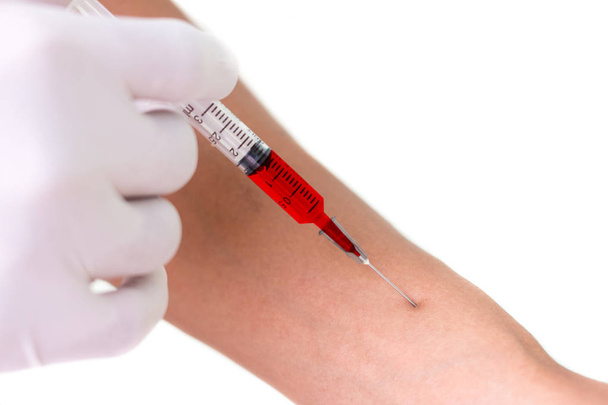 Médico inyectando paciente con jeringa para recoger sangre sobre fondo blanco
 - Foto, Imagen