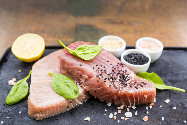 Raw tuna steak prepared for grilling. - Photo, image