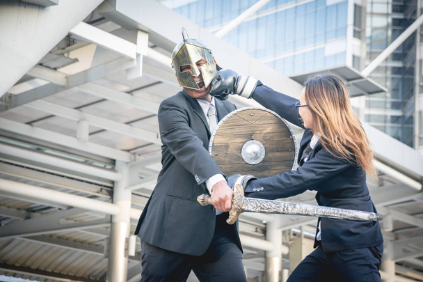 Knight businessman and boxer businesswoman fighting war on city  - Photo, Image