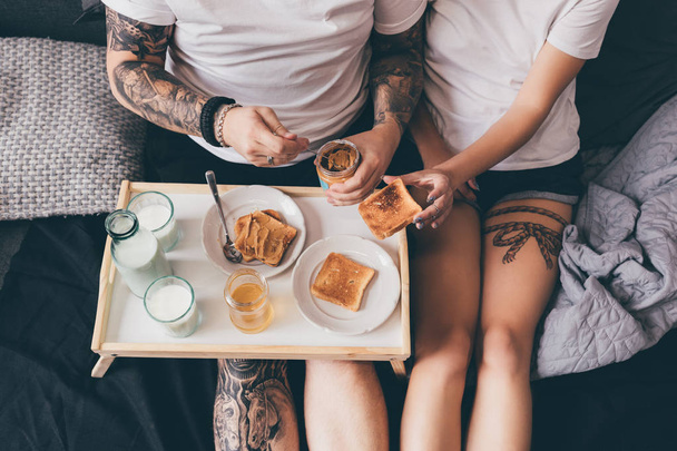 couple having breakfast together in bed - Photo, Image