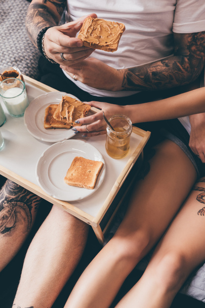 couple eating toasts in bed - Photo, Image