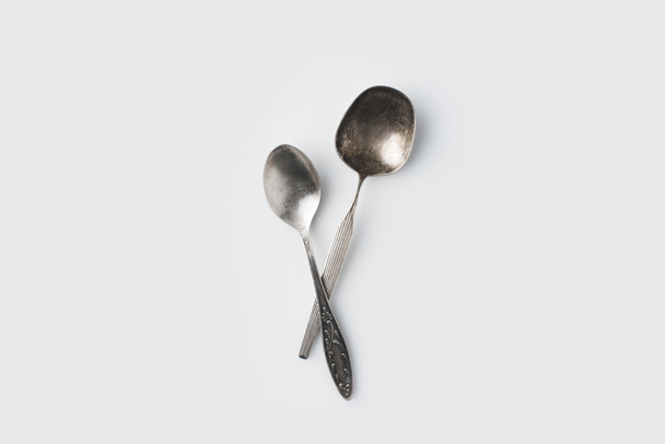 crossed spoons on white table - Photo, Image
