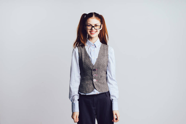 girl student with glasses smiling standing on white background - Foto, imagen