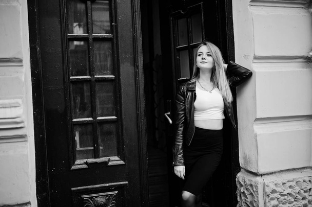 Elegant blonde girl wear on black leather jacket posing at stree - Foto, Imagem