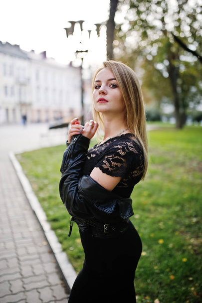 Elegant blonde girl wear on black leather jacket posing at stree - Фото, зображення