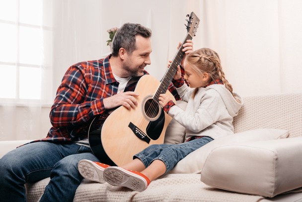 father and daughter playing guitar - Photo, image