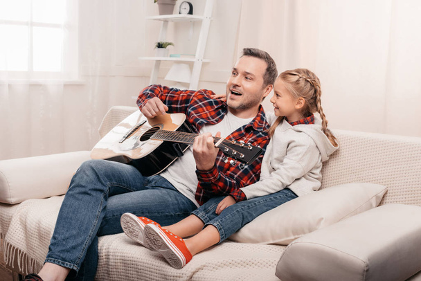 father and daughter playing guitar - Foto, afbeelding