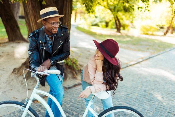 couple standing and leaning on bike - Photo, Image