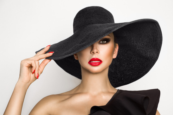 Portrait of an elegant woman in a hat and red lips on a white background - Photo, Image