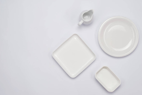Ceramic plates on white  - Фото, изображение