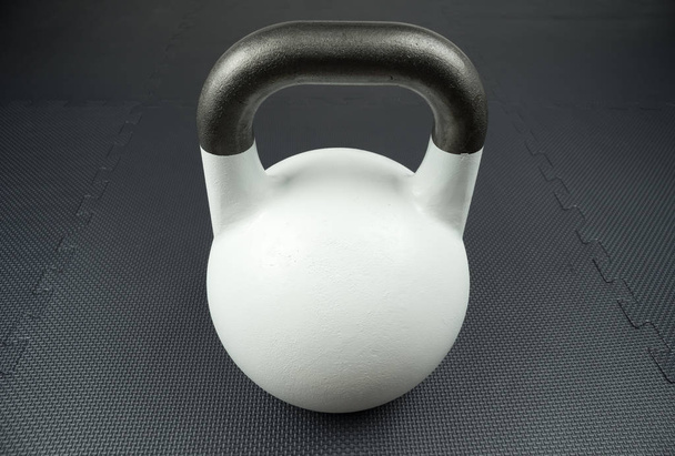 White competition kettlebell on a gym floor - Photo, Image