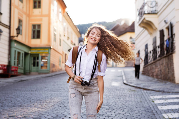 Young tourist with camera in the old town - 写真・画像