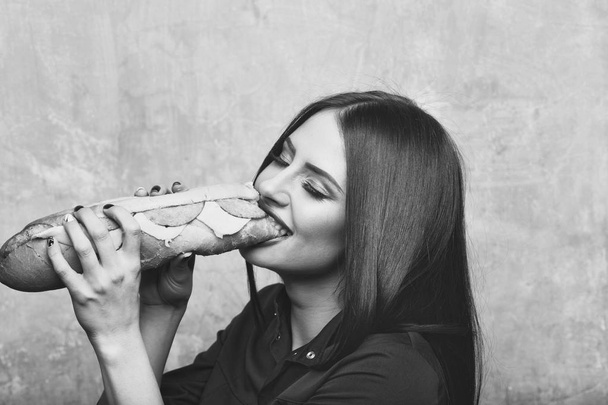sexy pretty brunette smiling woman eats big sandwich or burger - Φωτογραφία, εικόνα
