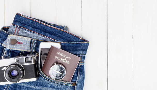 Hipster Jean with travel objects and equipment on wooden copy space - Фото, изображение