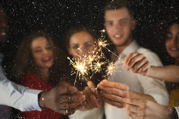 Sparklers background. Young people at celebration party - Photo, Image