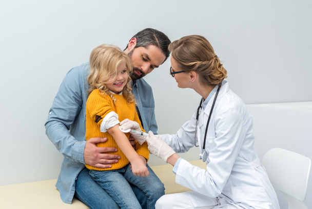 doctor doing vaccination for little girl - Foto, Imagen