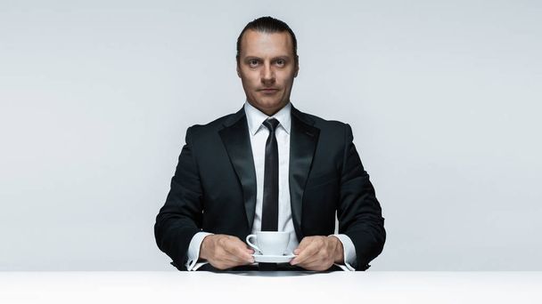 The attractive man in black suit on white background - Foto, Imagem