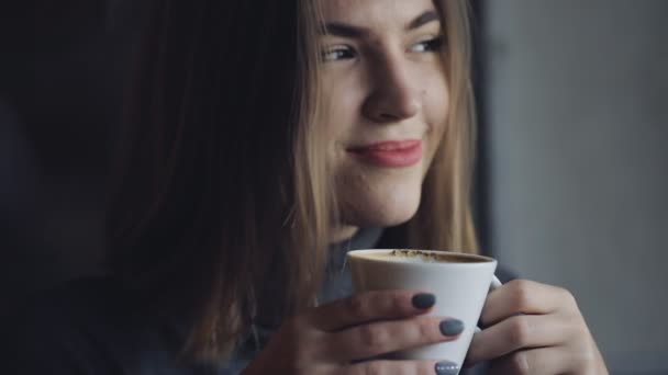 Woman drink coffee in cafe - Кадри, відео