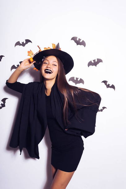 young sexy mysterious girl dressed in a witch, celebrates halloween, laughs - Foto, Imagen