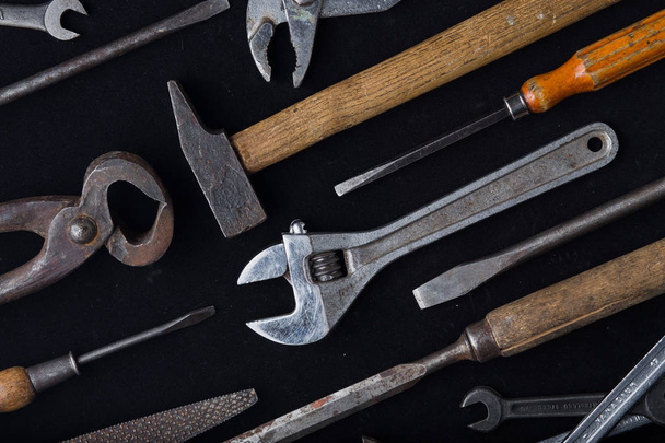 Construction tools set on dark background. Assortment instruments for repairman, carpenter, builder. Copy space for text. Top view - 写真・画像