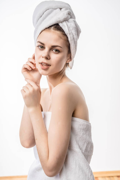 girl with a towel on her head feels her face - Foto, Imagem