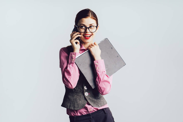 girl secretary wearing glasses smiling talking on the phone - Fotoğraf, Görsel