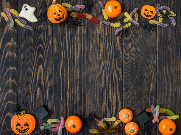 Halloween background with candy and cookies - Фото, изображение