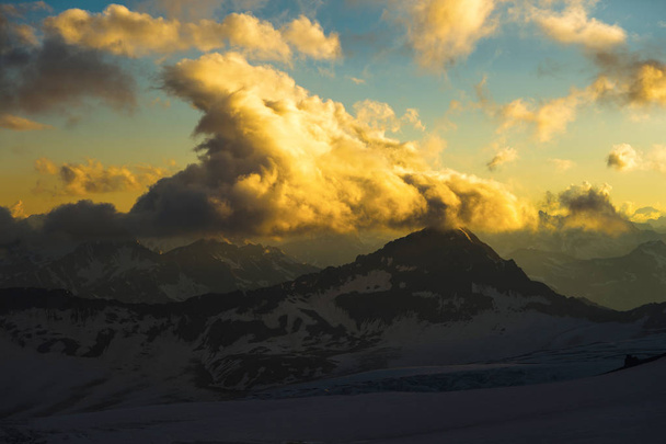 Sunset panorama of the elbrus and part of the Caucasian ridge - Photo, image