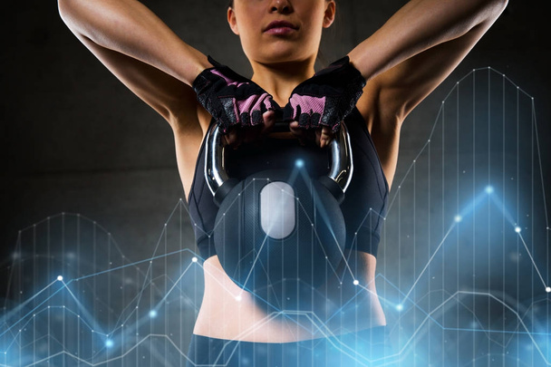 woman with kettlebell in gym - Fotó, kép