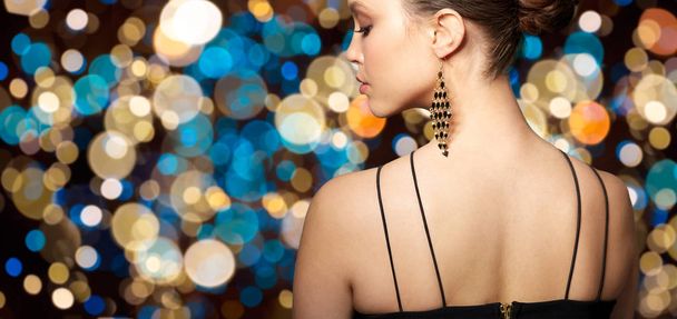 close up of beautiful woman face with earring - 写真・画像