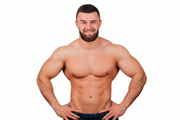 Portrait of a strong bearded male fitness model, torso. White background, isolate. hands on his hips. - Foto, Imagem