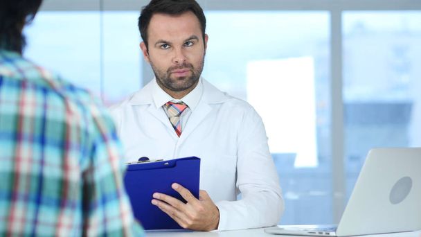 Doctor Talking with Patient about Bad Health News, Patient Reaction - 写真・画像