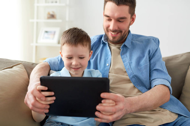 father and son with tablet pc playing at home - Valokuva, kuva