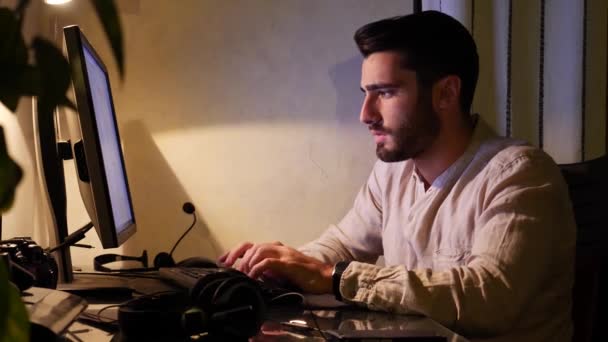 Home worker sitting at desk using touchscreen computer - Felvétel, videó