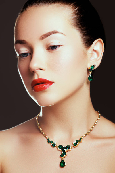 Portrait of luxury girl with jewelry. Model girl in expensive earrings. Beautiful woman with emerald necklace. Beauty young model with emerald pendant. Jewellery and accessories. Beauty salon - Foto, immagini