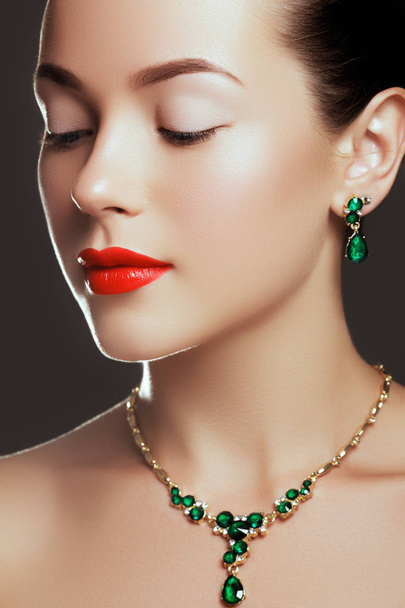 Portrait of luxury woman with jewelry. Model in expensive earrings. Beautiful woman with emerald necklace. Beauty young model with emerald pendant. Jewellery and accessories. Fashion and beauty salon - Foto, immagini