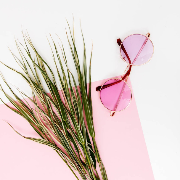 Minimal style. Minimalist Fashion photography. Fashion sunglasses. Summer is coming concept. Pink glasses on a pastel background, top view. Trendy minimal style with colorful paper backdrop - Photo, Image