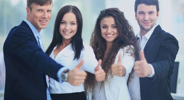 Happy business team with thumbs up in the office - Фото, зображення
