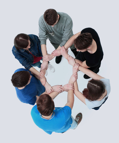 Top view of young people with their hands together in a circle. - Foto, imagen