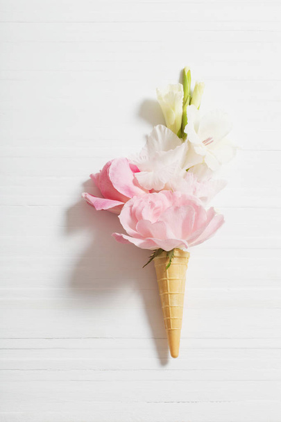 flowers in waffle cone on wooden background - Фото, изображение
