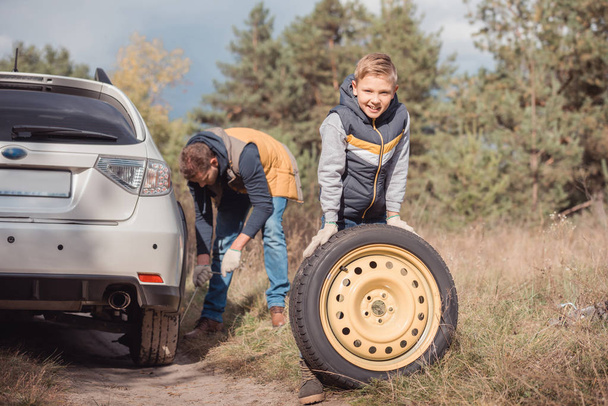 Father and son changing car wheel - Photo, Image