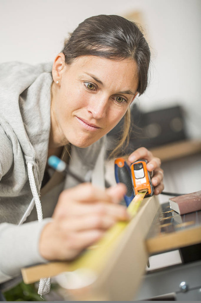 Portrait of woman doing DIY work at home - Photo, Image
