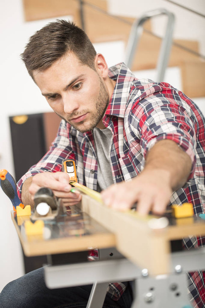 Man working on wood planks for home-improvement - Photo, Image