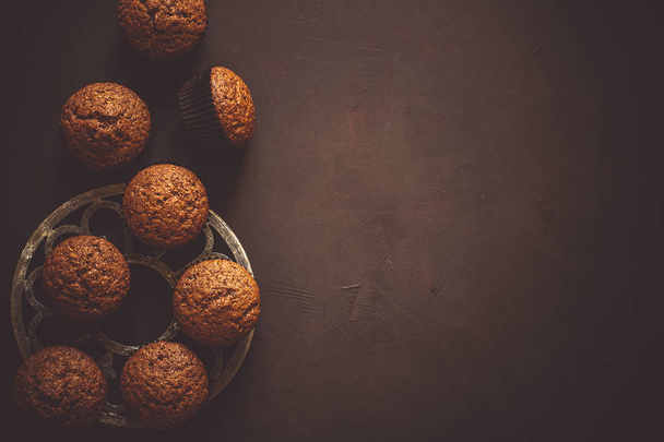 Homemade chocolate muffins on brown wooden desk - Foto, imagen