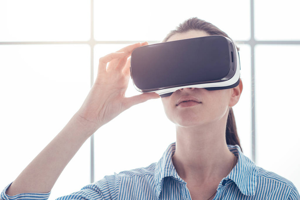 Young woman  wearing VR headset - Фото, зображення