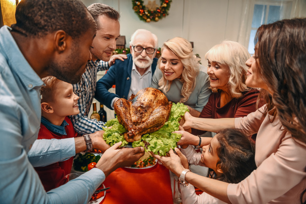 large family holding christmas turkey - Photo, Image