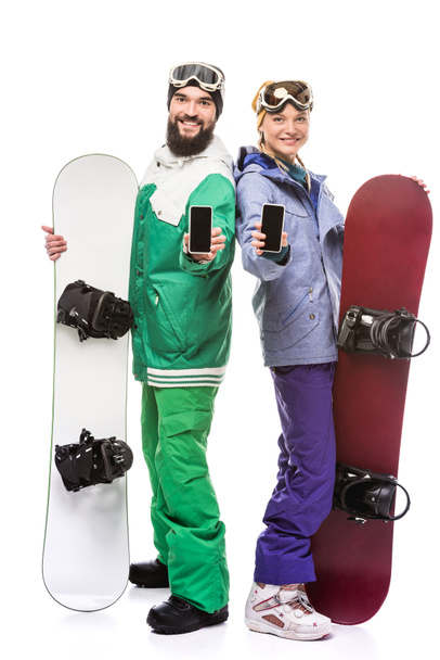 snowboarders sonrientes con smartphones
 - Foto, Imagen