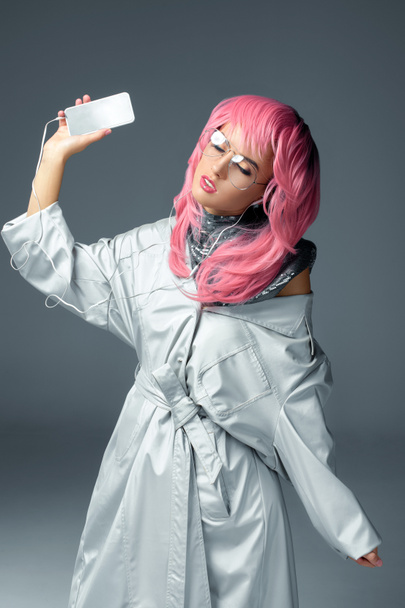 stylish girl with earphones and smartphone - Фото, изображение