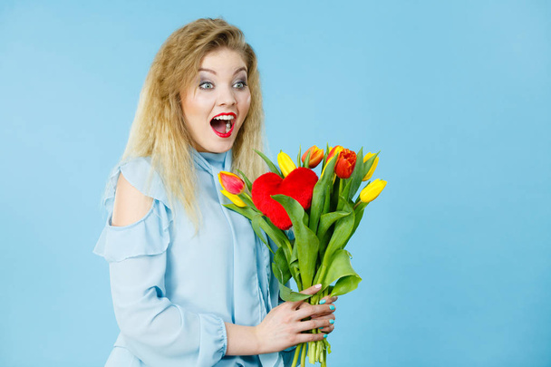 Pretty woman with red yellow tulips bunch - Foto, imagen