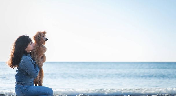 Woman with her dog at sandy sea beach .  - Fotografie, Obrázek